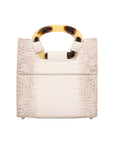Back of a white textured handbag on a white background