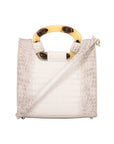 White textured handbag with a strap on a white background