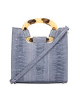 Blue textured handbag with a strap on a white background