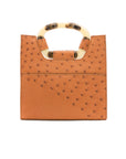 Back of a cognac ostrich textured handbag on a white background