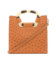 Front of a cognac ostrich textured handbag with a strap on a white background