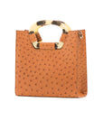 Front of a cognac ostrich textured handbag on a white background