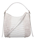 White handbag with crocodile texture on a white background