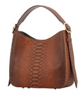 Side of a brown caramel python textured handbag with a strap on a white background
