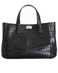 Front of a black crocodile textured handbag on a white background