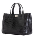 Side of a black crocodile textured handbag on a white background