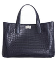Front of a navy crocodile textured handbag on a white background