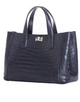 Side of a navy crocodile textured handbag on a white background