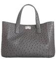 Front of an anthracite ostrich textured handbag on a white background