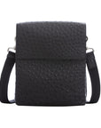 Black ostrich textured messenger bag on a white background
