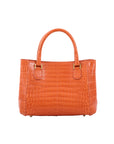 Orange handbag with a crocodile pattern on a white background