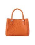 Orange handbag with a textured pattern on a white background