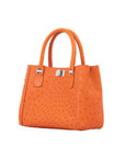 Orange handbag with a textured pattern on a white background