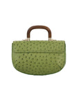 Back of a green ostrich handbag with a wooden handle on a white background