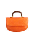 Front of a tangerine crocodile textured handbag with wooden handle on a white background