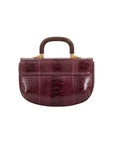 Back of maroon handbag with a wooden handle on a white background