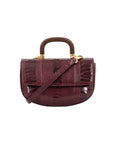 Fron of maroon handbag with a wooden handle and strap on a white background