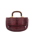 Front of maroon handbag with a wooden handle on a white background