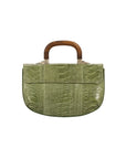 Back of a green ostrich leg handbag with a wooden top handle on a white background