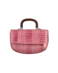 Front of a pink textured handbag with wooden handle on a white background
