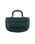 Back of a green crocodile skin handbag with wooden handle on a white background