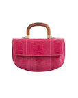 Front of a pink handbag with wooden handle on a white background