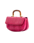 Side of a pink handbag with wooden handle on a white background