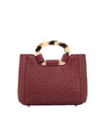 Front of maroon ostrich handbag with a handle on a white background
