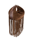 Side of cognac suede handbag with fringe details on a white background