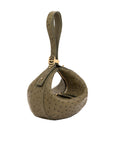 Green ostrich-handbag with a gold clasp on a white background