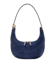 Blue suede handbag with gold accents on a white background