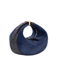 Blue suede handbag with gold accents on a white background