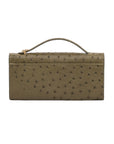 Jungle green ostrich textured clutch bag on a white background