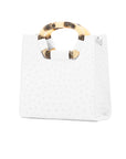 Side of a white ostrich textured handbag on a white background