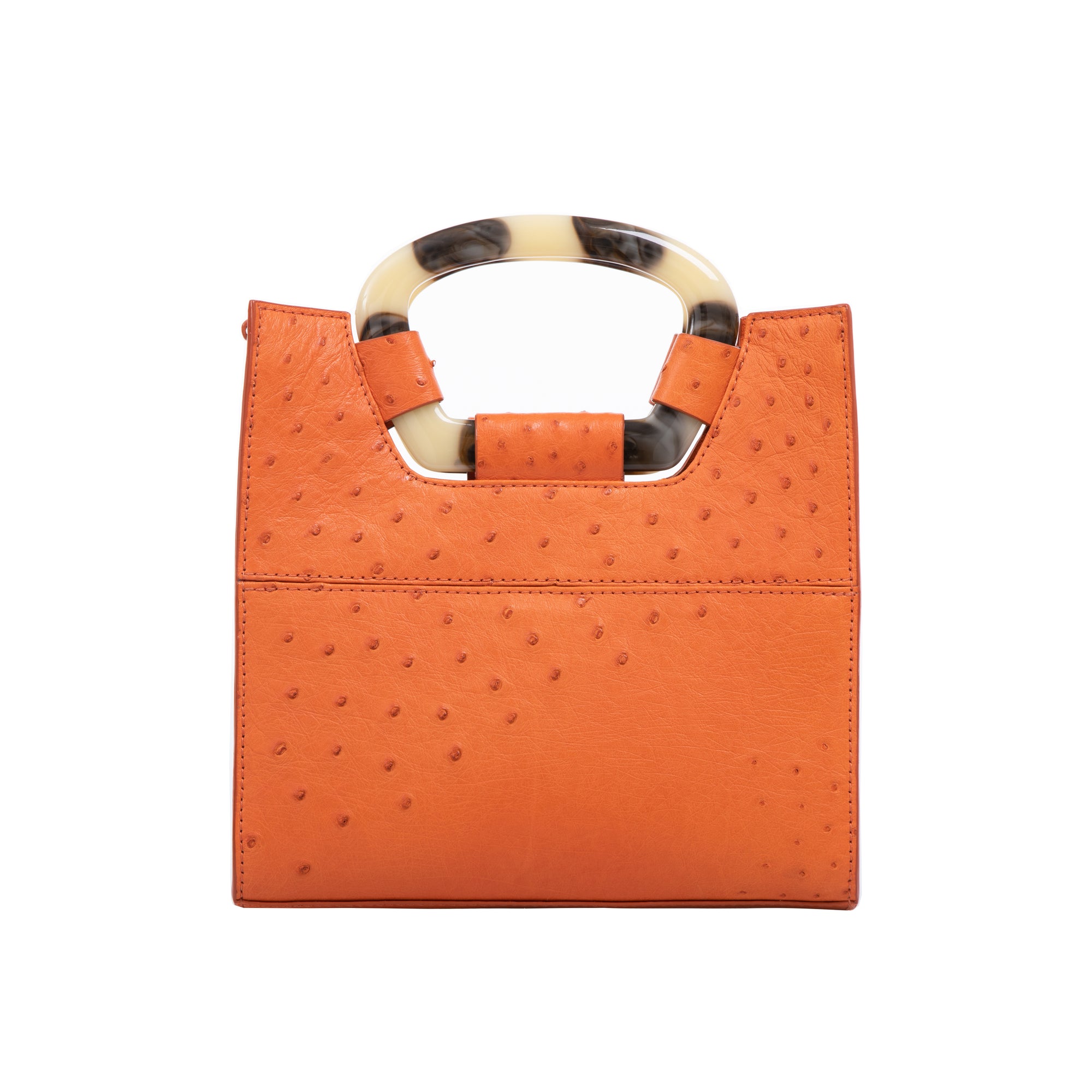 Back of a tangerine ostrich textured handbag on a white background