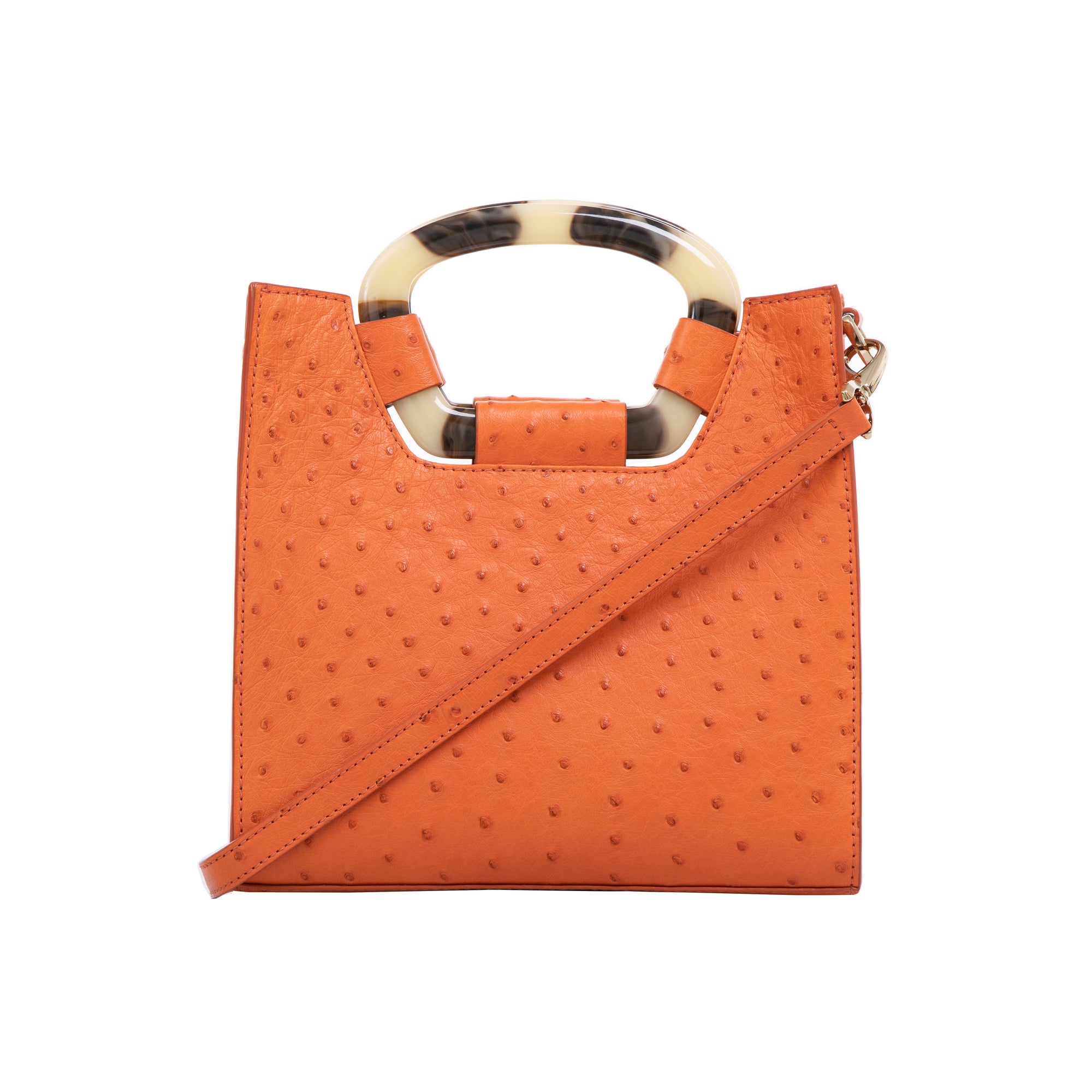 Front of a tangerine ostrich textured handbag with a strap on a white background