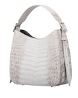 Side of a white crocodile textured handbag on a white background