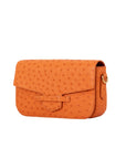 Side of a tangerine ostrich textured clutch bag on a white background