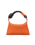 Orange textured handbag with a brown rope handle on a white background