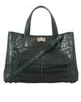 Green crocodile-patterned handbag with a shoulder strap on a white background