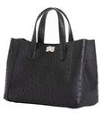 Side of a black ostrich textured handbag on a white background