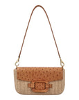 Front of a brown and beige ostrich and woven handbag with a strap on a white background