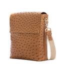 Brown ostrich textured messenger bag on a white background