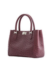 Maroon handbag with a textured pattern on a white background