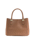 Brown textured handbag with gold accents on a white background