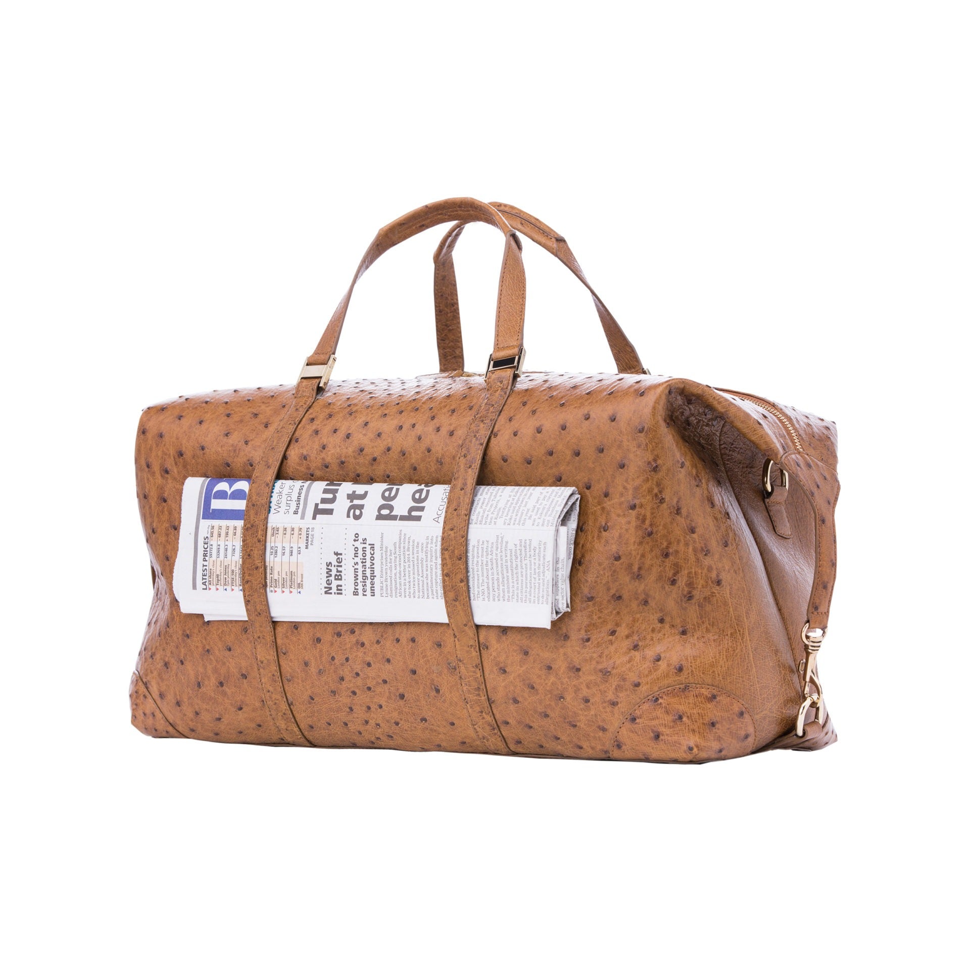 Large brown ostrich bag with straps and a newspaper on a white background