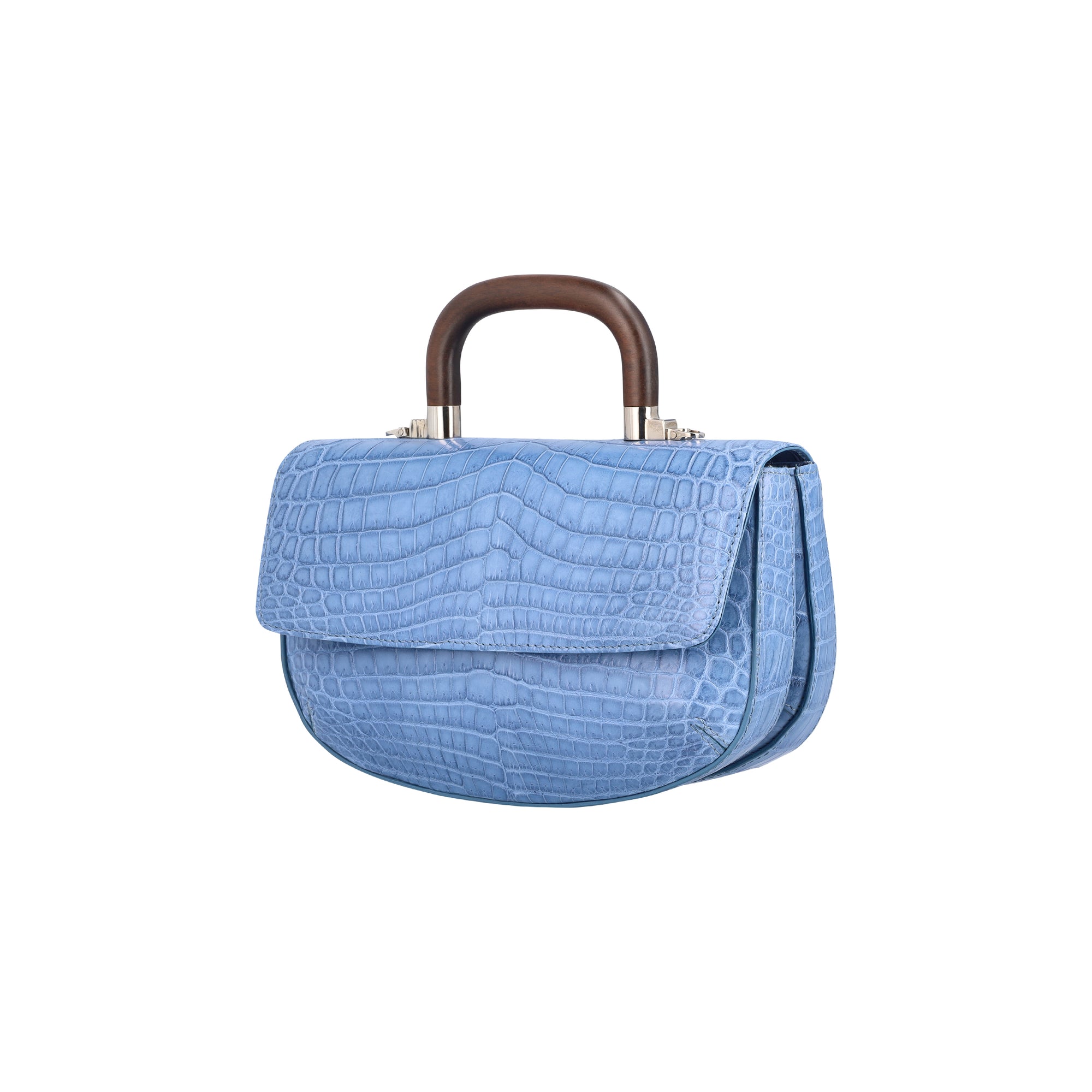 Side of a blue crocodile handbag with a wooden handle on a white background