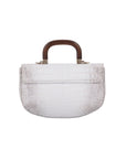 Back of a white crocodile handbag with a wooden handle on a white background