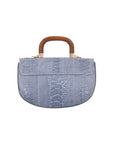 Back of a blue textured handbag with wooden handle on a white background