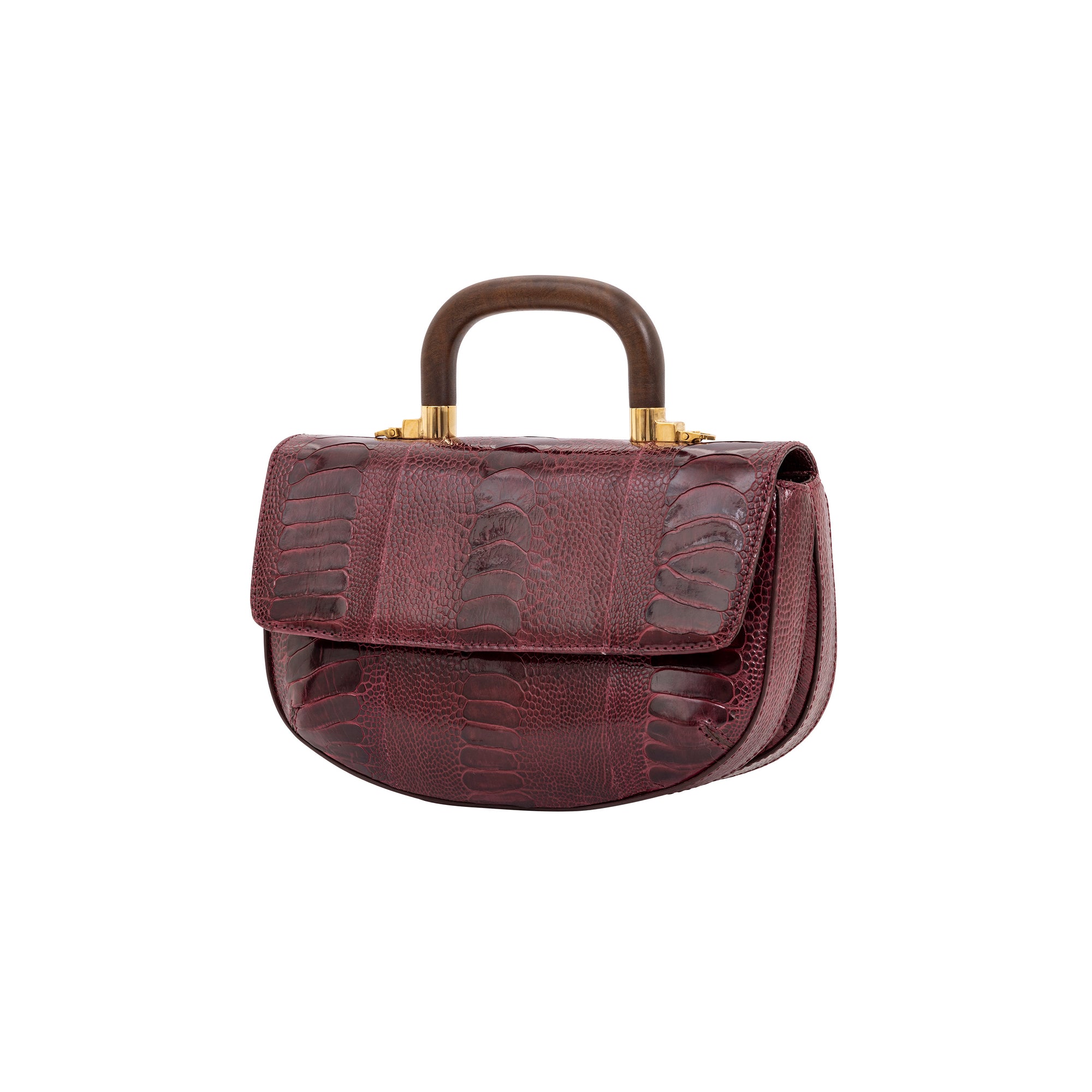 Side of maroon handbag with a wooden handle on a white background